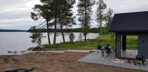 een huis met een patio naast een meer bij VillaNorva in Saarenkylä