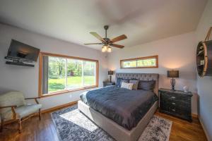 a bedroom with a bed and a ceiling fan at Spacious Lakeside Family Home on Big Bearskin Lake in Hazelhurst