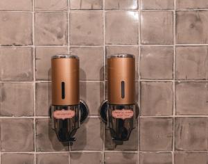 two brown cups sitting on a tiled floor at El Edén Hotel Boutique in Pátzcuaro