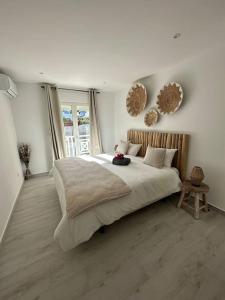a bedroom with a large bed and a large window at Orient Bay, Appartement Héliconia. in Saint Martin
