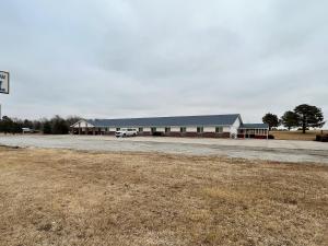 an empty parking lot in front of a building at The Trail Inn - Sutton, Nebraska - US-6 HWY 