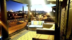 a balcony with a couch and a view of a city at Casa Mina #3 Central Rio Grande Historic Dist in El Paso