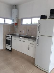 a kitchen with white appliances and a white refrigerator at Brisas de San Rafael in San Rafael