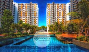a large swimming pool with buildings in the background at Timurbay Seafront Residence byDiamond Studio Suites 1 plus 1 in Kuantan