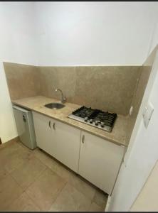 a kitchen with a sink and a counter top at Ground Floor Studio With Garden in Sheikh Zayed