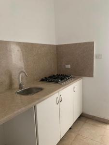 a kitchen with a sink and a stove at Ground Floor Studio With Garden in Sheikh Zayed