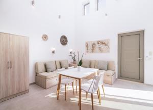 a white living room with a table and chairs at Matala Prime Villas in Matala