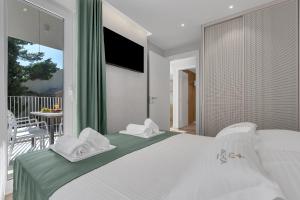 a bedroom with a bed with white towels on it at Villa Anchor in Baška Voda