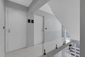 a bathroom with white walls and a large mirror at Villa Anchor in Baška Voda +134 photos