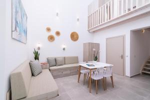 a living room with a couch and a table at Matala Prime Villas in Matala