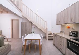 a kitchen with a table and chairs and a staircase at Matala Prime Villas in Matala
