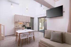 a living room with a table and a couch at Matala Prime Villas in Matala