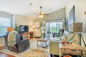a living room with couches and a tv at Holiday Hills Resort Condo Mins to Branson Strip! in Branson