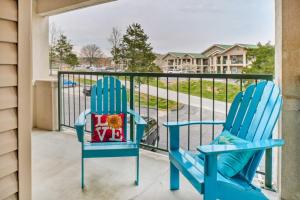 two blue chairs sitting on a balcony at Holiday Hills Resort Condo Mins to Branson Strip! in Branson