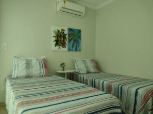 Postel nebo postele na pokoji v ubytování Triplex Beach Selma