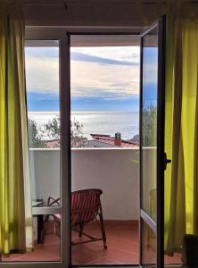 a view of the ocean from the balcony of a house at Apartment Vukica with free parking in Petrovac na Moru