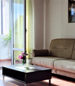 a living room with a couch and a coffee table at Apartment Vukica with free parking in Petrovac na Moru