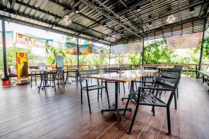 a group of tables and chairs in a restaurant at Banana Resort Sadao in Sadao
