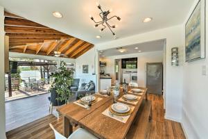a dining room and living room with a wooden table at Luxury Home with Pool on San Jacinto Riverfront! in Houston