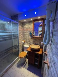 a bathroom with a shower and a toilet and a sink at Omarina in Le Marin