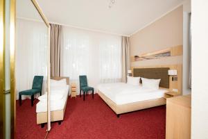 Postel nebo postele na pokoji v ubytování Garni Eden Hotels