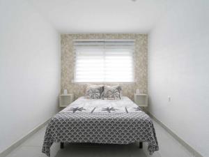 Ένα ή περισσότερα κρεβάτια σε δωμάτιο στο Mahostly Apartamento Ocean View