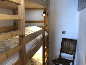 a couple of bunk beds in a room with a chair at Appartement Avoriaz, 2 pièces, 5 personnes - FR-1-634-75 in Morzine