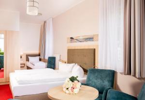 Ein Bett oder Betten in einem Zimmer der Unterkunft Hotel Garni Sonne