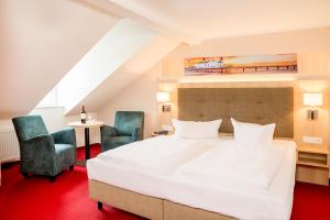 Ein Bett oder Betten in einem Zimmer der Unterkunft Hotel Garni Sonne