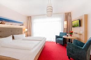 Ein Bett oder Betten in einem Zimmer der Unterkunft Hotel Garni Sonne