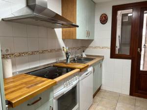 a kitchen with a sink and a stove at Ayamonte Vista Esuri Golf - 12 min to Isla Canela in Huelva
