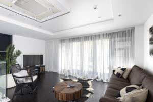 a living room with a couch and a table at Mount Views in Mount Maunganui