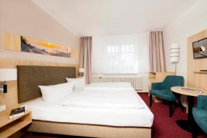 Postel nebo postele na pokoji v ubytování Garni Eden Hotels