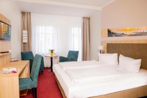 Postel nebo postele na pokoji v ubytování Garni Eden Hotels