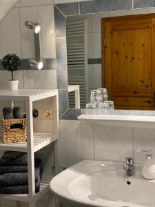 ein Bad mit einem Waschbecken und einem Spiegel in der Unterkunft Ferienhaus Marie in Wernigerode
