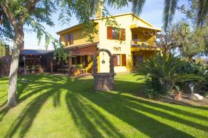 a yellow house with a lush green yard at Catalunya Casas Incredible secluded villa, just 11km from Beach! in La Selva del Camp