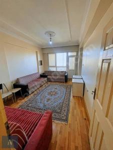 a living room with two couches and a rug at Suit home and room in city center in Erzurum