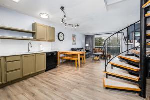 a kitchen with a staircase leading to a living room at Cozy Crystal Mountain Condo in Girdwood