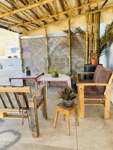 a patio with two tables and two chairs and a table at Hostel Mindelo in Mindelo