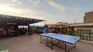 a ping pong table sitting on top of a patio at 1900 Backpacker's Hostel in Lima