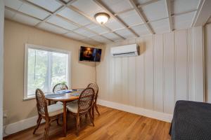 a dining room with a table and chairs and a window at Lakeshore Fishing Cabins #4 in Lake Ozark