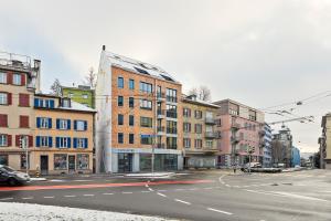 an empty city street with buildings and a road at Liv Suites in Luzern