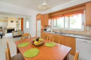 a kitchen with a table with a bowl of fruit on it at Garden House with sea view in Faliraki