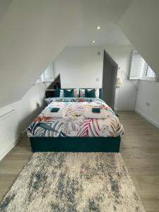 a bedroom with a large bed in a attic at The Bolt Hole Hythe panoramic coast and sea views in Kent