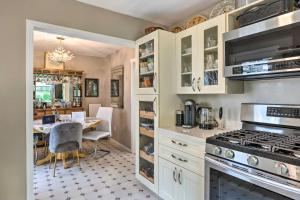 a kitchen with a table and a dining room at Cute East Hampton Cottage with Patio - Walk to Beach in East Hampton +17 photos
