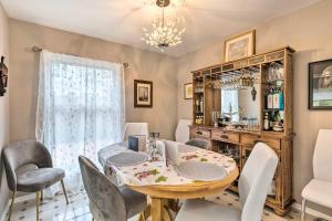 a dining room with a table and chairs and a mirror at Cute East Hampton Cottage with Patio - Walk to Beach in East Hampton