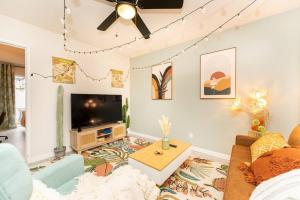 a living room with a couch and a tv at Seaside Romantic Escape Steps to Beach in Oceanside