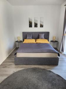 um quarto com uma cama grande e almofadas amarelas em Alice Central Apartment em Budapeste