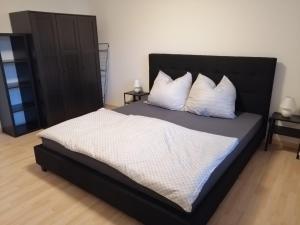 a bedroom with a large bed with white sheets and pillows at Zum Feldstein in Themar