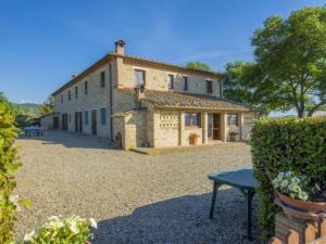 a large stone building with a bench in front of it at Tenuta La Casetta in Casciana Terme